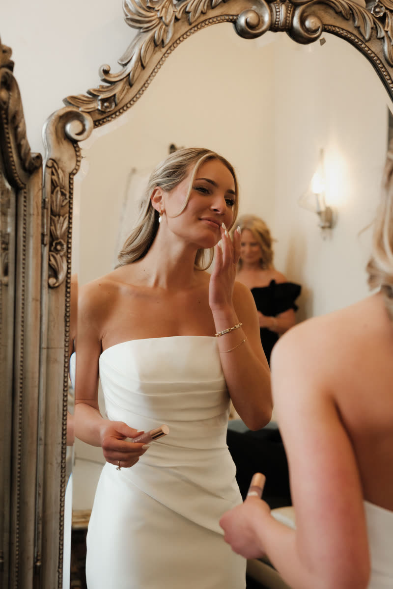 Bride blending a lip product with her fingertip